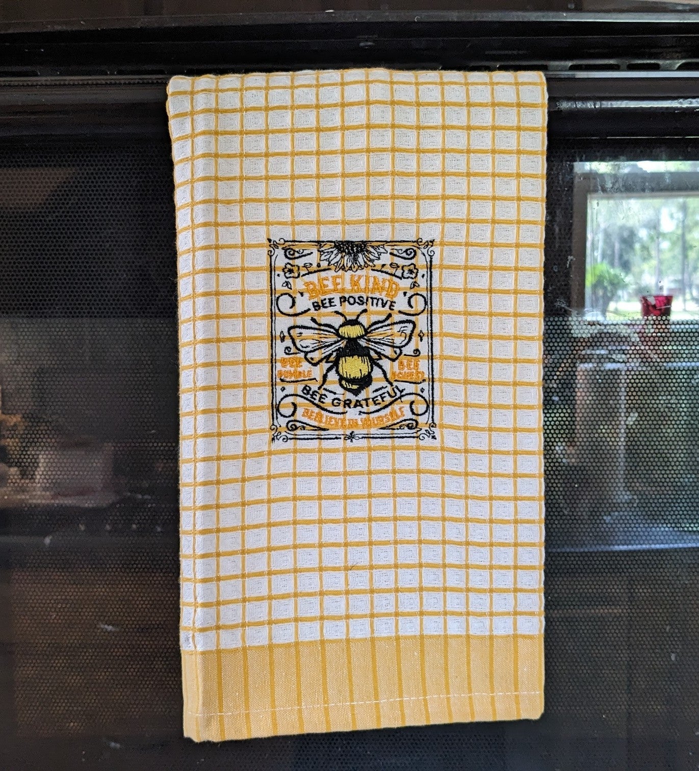 Cotton towel featuring bee embroidery pattern